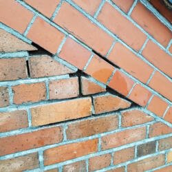 Failed cement pointing has left brickwork exposed